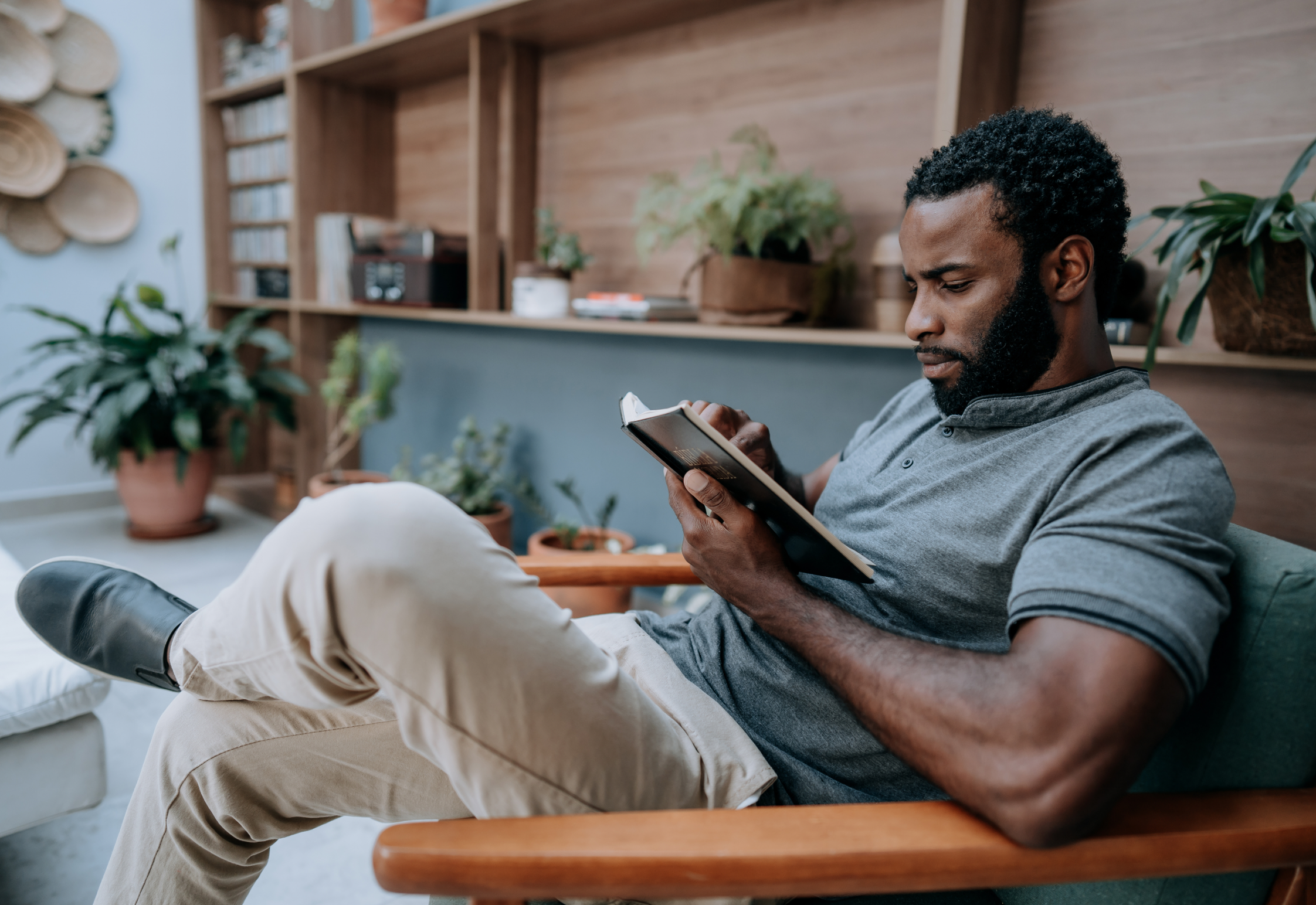 Man reading book on couch